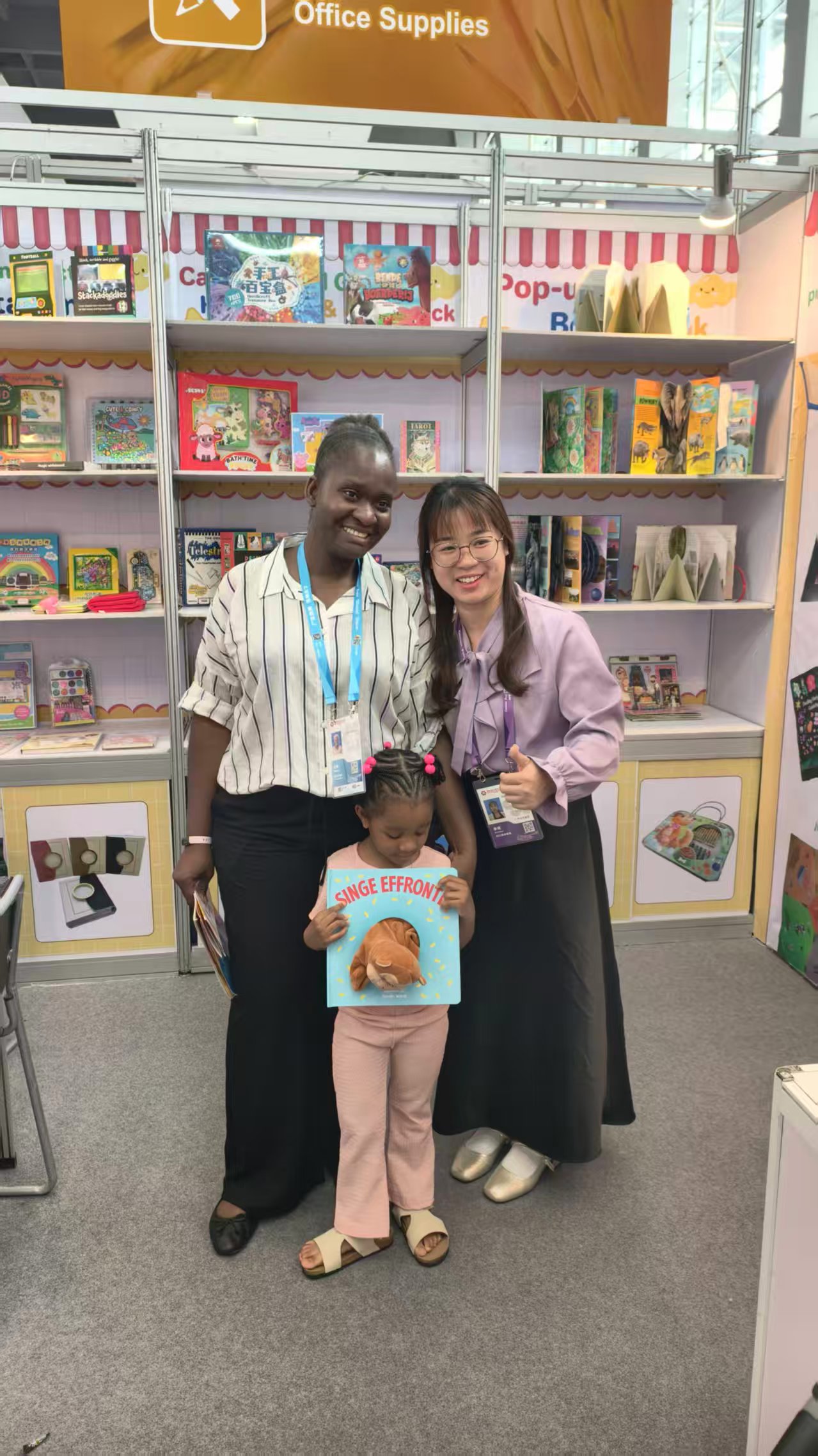 DaKings team with African publisher and child holding our book